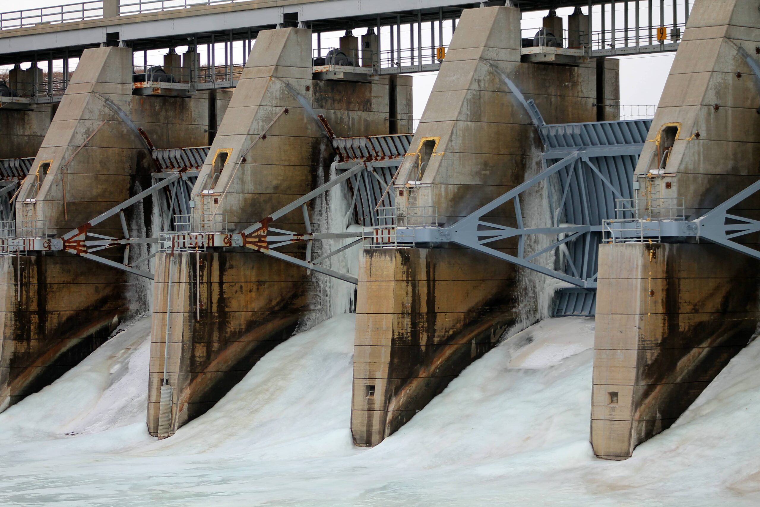 Photo of a dam with spillway gates releasing water in Gavins Point